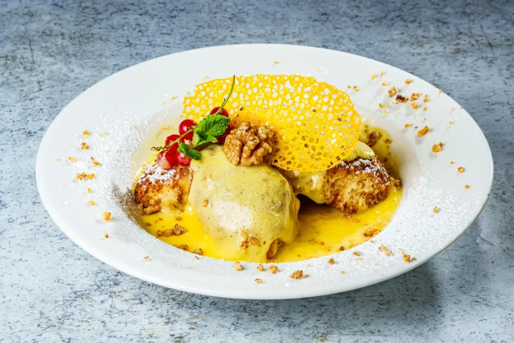 ‘Golden gnocchi’ (baked dough balls with butter, raisins and nuts) with vanilla custard