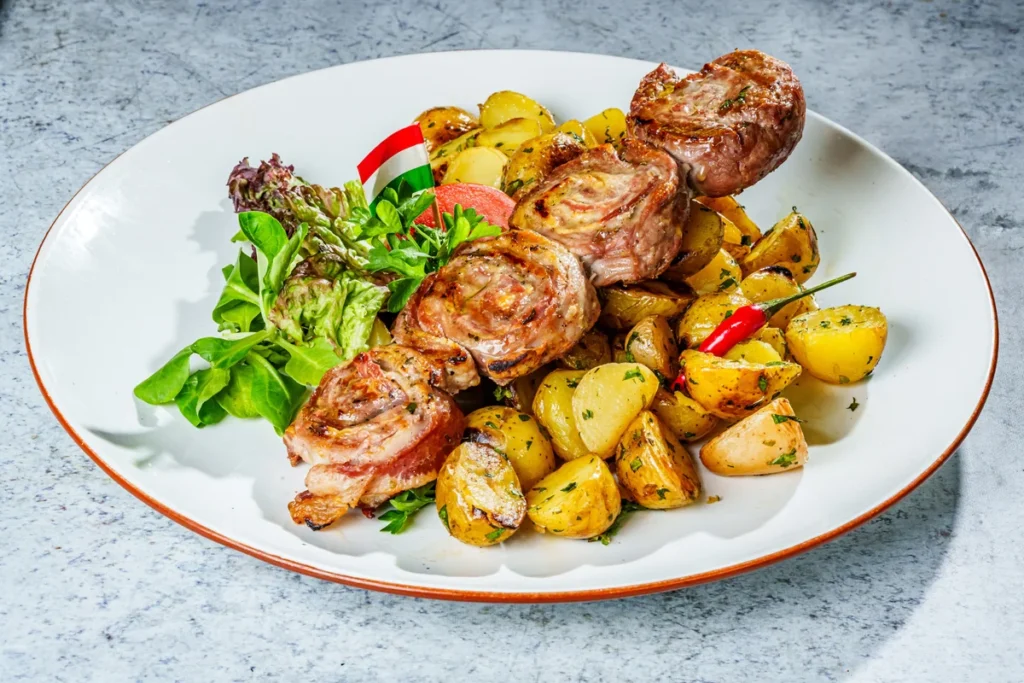 Pork tenderloin with Mangalica bacon on a skewer, with parsley potatoes